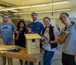 The team working in the College of Design’s woodworking space during the squirrel box-building event. Photo credit: Thomas Bordeaux, ARCH 2022. 