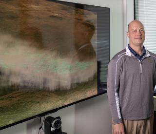 Researcher Michael Peterson with a visualization of the record lightning flash