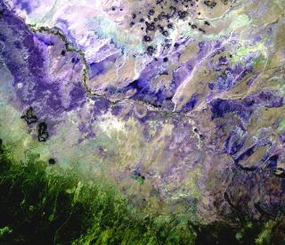 In the Painted Desert of Northern Arizona (shown here in a palette of purples), wet-dry cycling has contributed to the formation of the colorful layers visible in the landscape. (Credit: USGS)